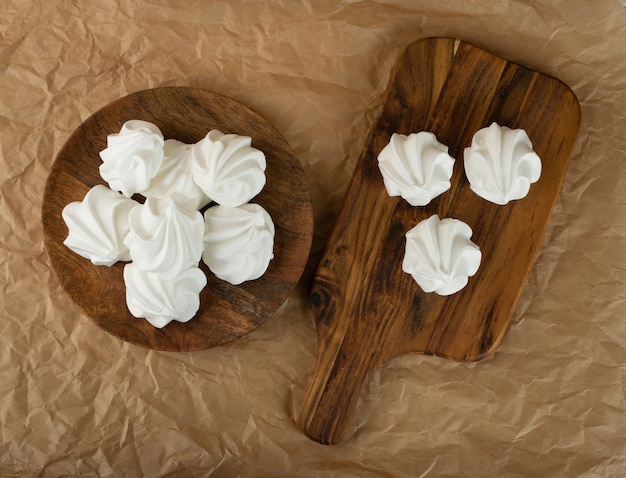 White meringue cookies made from whipped egg whites and sugar top view. Traditional whisk merengues, baked whisking cream or beze