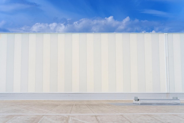 White metal sheet rooftop wall on commercial building with blue sky