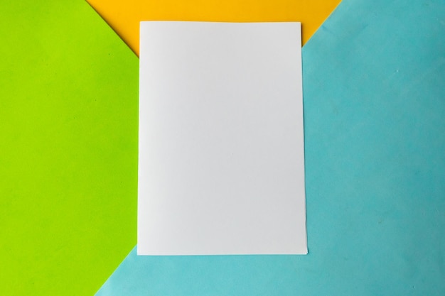 White mockup blank on geometric blue green and yellow background