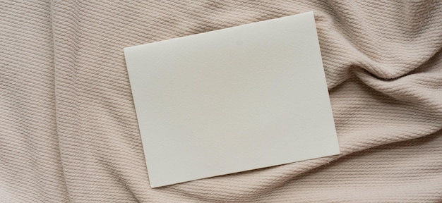 white mockup blank paper on ripple and crumpled fabric texture background for minimal design