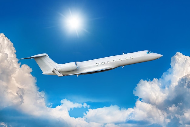 White modern luxury corporate airplane fly in the air above the clouds