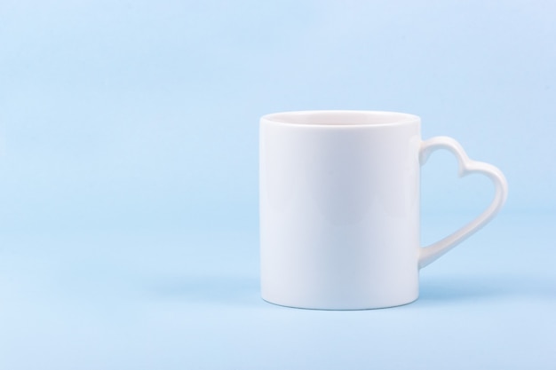 White mug on blue background