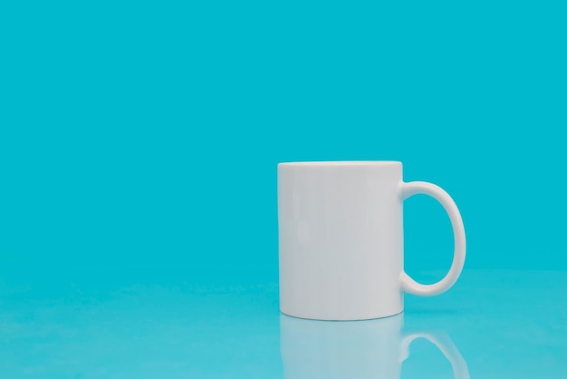 White mug on blue background