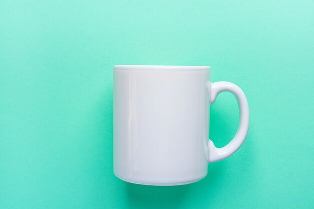 White Mug on Light Turquoise Background.