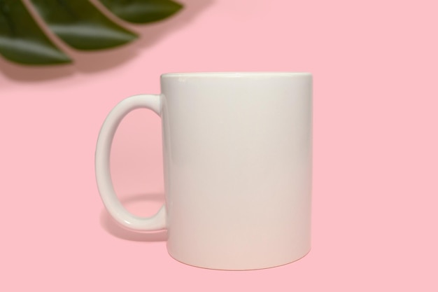 White mug on a pink background Layout for design Closeup