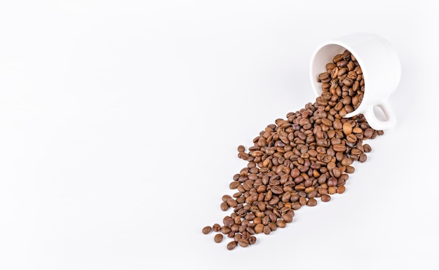 white mug with coffee beans on a light background