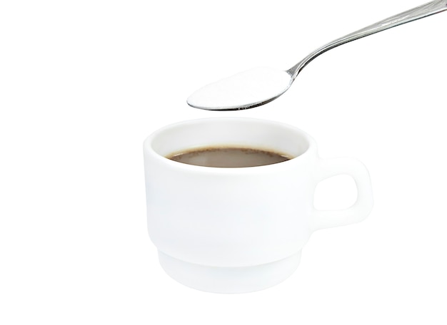 white mug with coffee and spoon with dry cream isolate