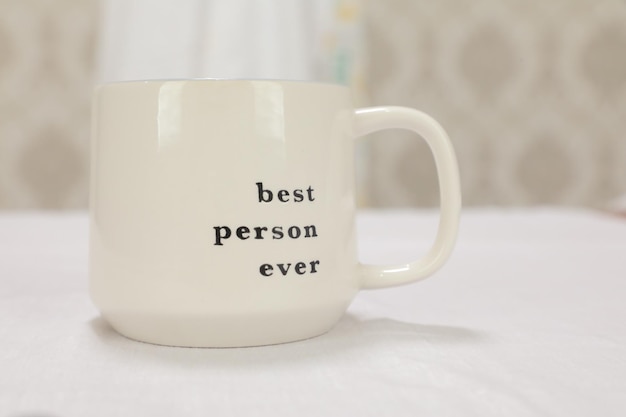 A white mug with the words best person ever on it