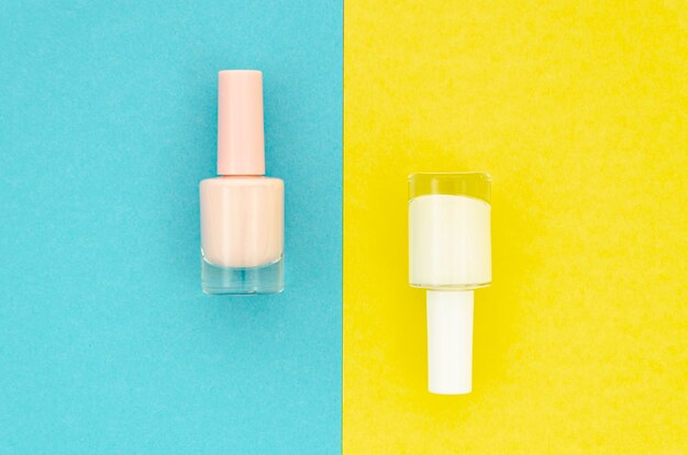 White nail polish on yellow and blue background