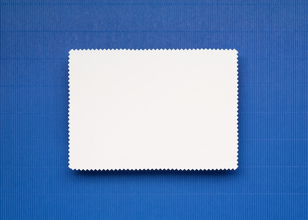 White note paper sheet on blue background