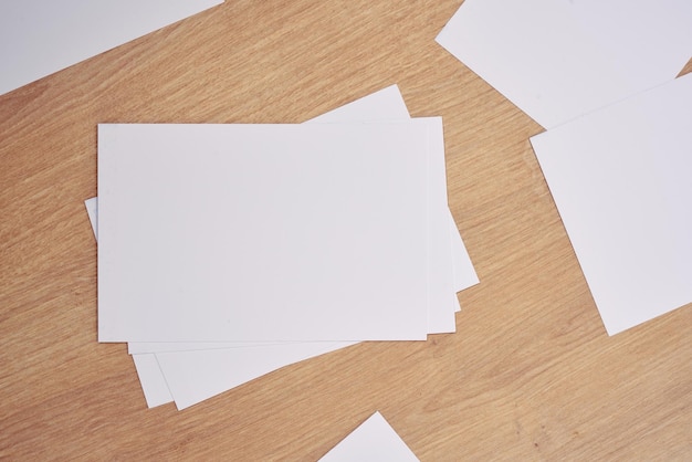 White note papers on a wooden table.      