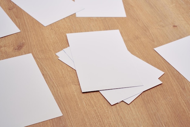 White note papers on a wooden table.      