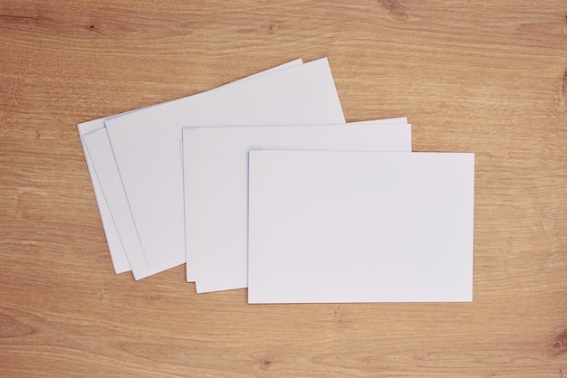 White note papers on a wooden table.      