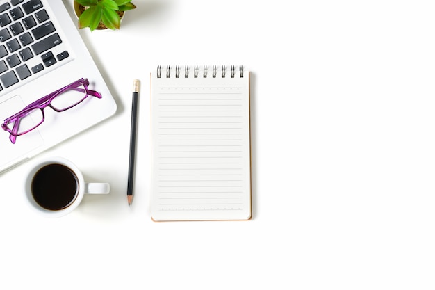 White office desk table with blank notebook