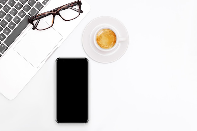 White office desk table with a laptop and phone Top view with copy spacexD