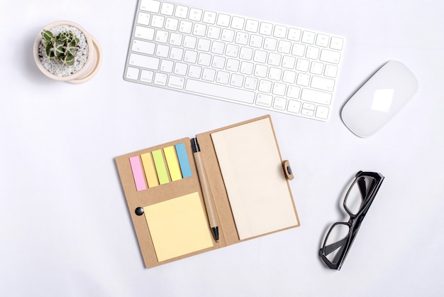 White office desk table with a lot of things on it. Top view with copy space