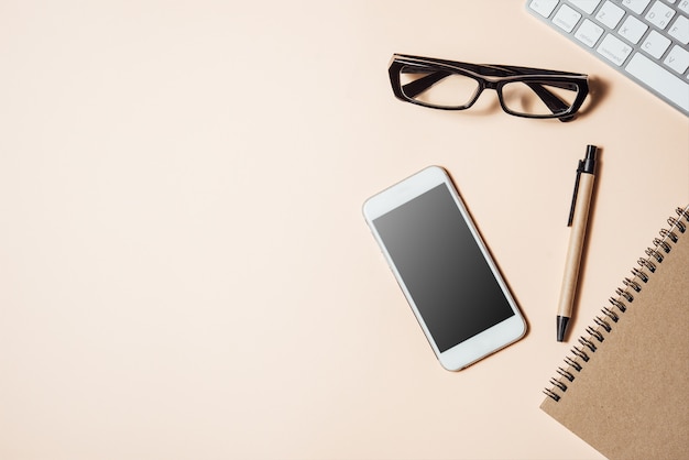 Photo white office desk table with a lot of things on it.