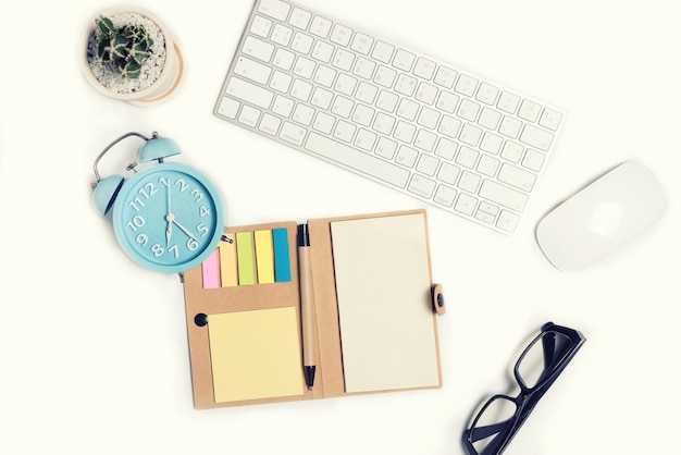 White office desk table with a lot of things on it