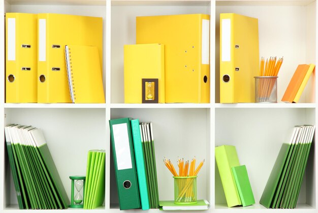 White office shelves with different stationery close up