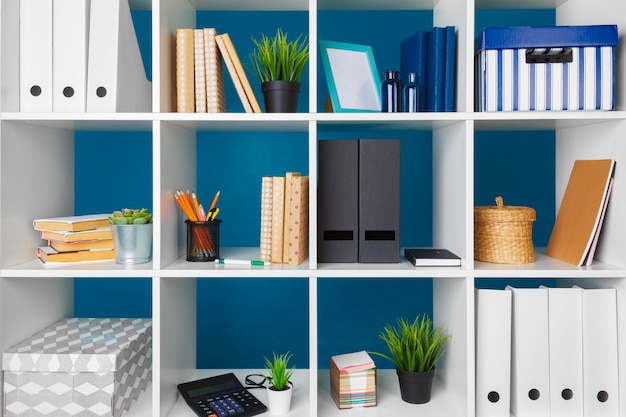 White office shelves with different stationery, close up