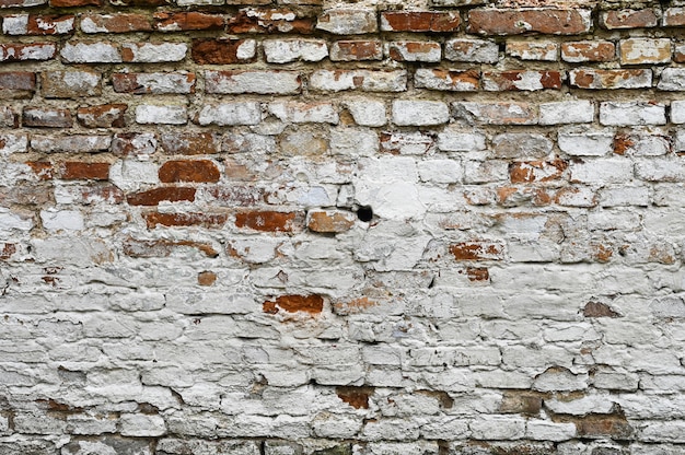 White old cracked brick wall