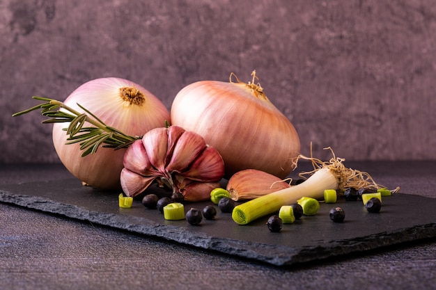 White onion and heads of garlic with a young garlic