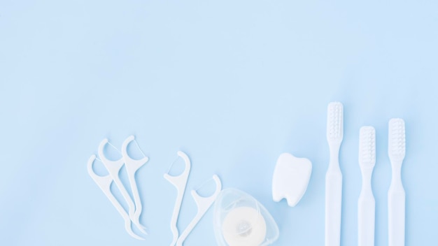 White oral care tools on blue background