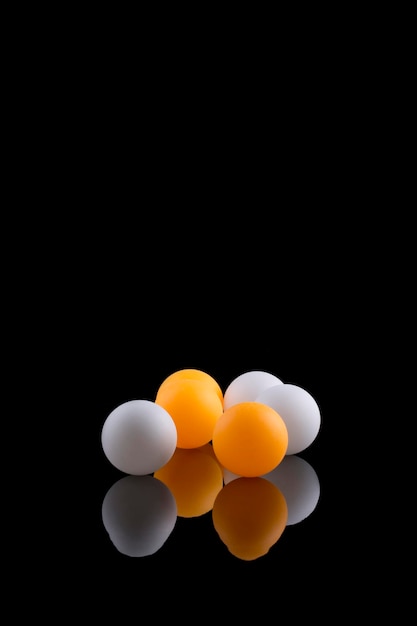 White and orange balls on a black background