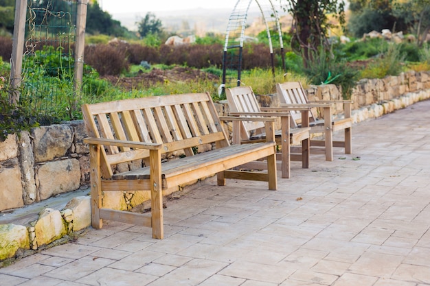 White outdoor furniture. Lounge chairs in hotel garden invite you to relax.