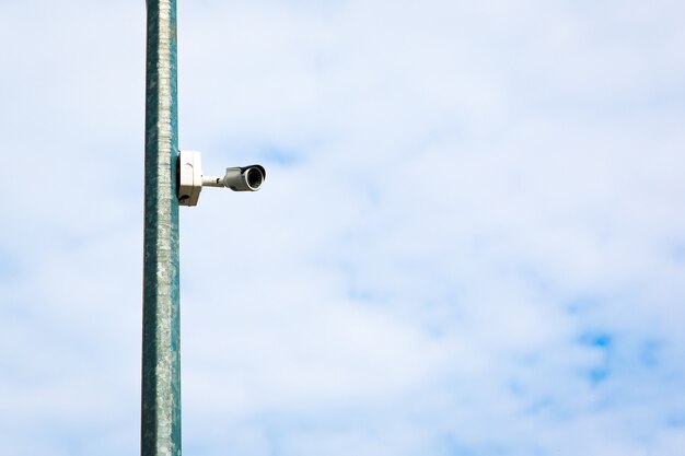 white outdoor surveillance camera in the city