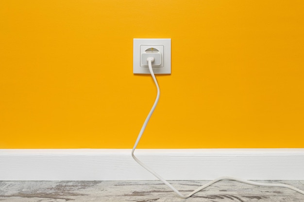 White outlet on yellow wall