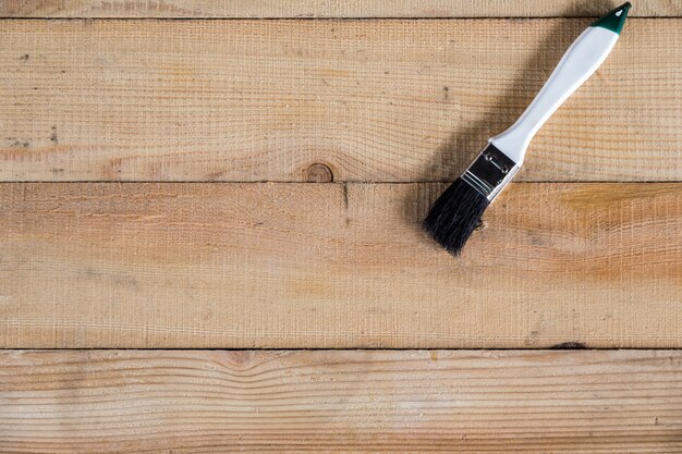 the white paint brush on wooden background