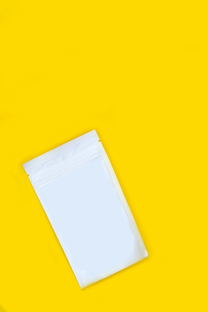 White paper bag on a yellow background