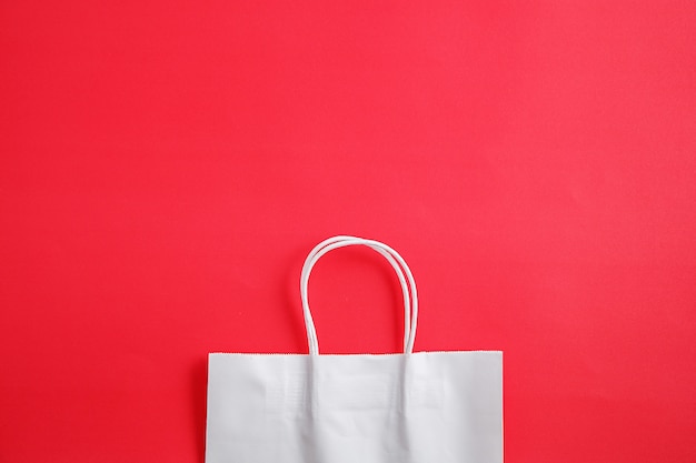 White paper bags on red background