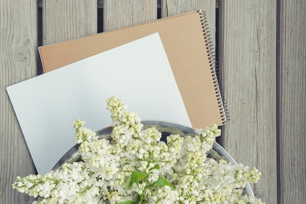 White paper card with closeup white lilac flowers