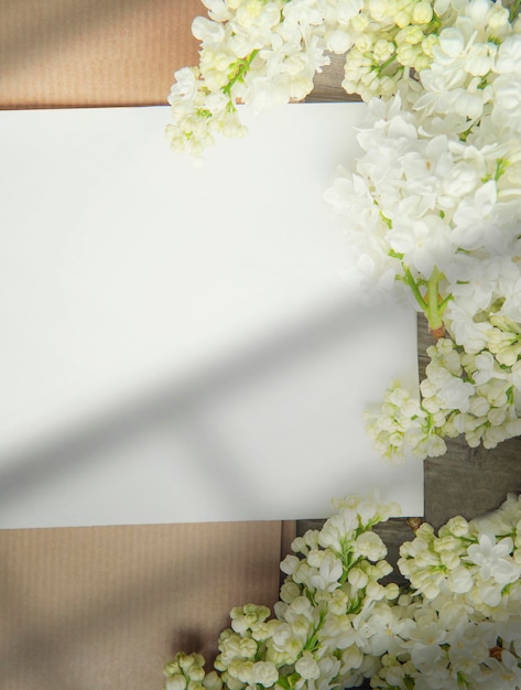 White paper card with white lilac flowers