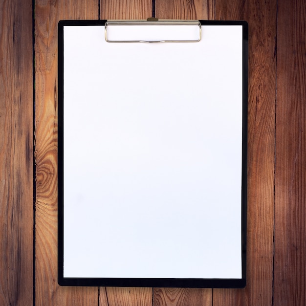 white paper clipboard on wood background and texture