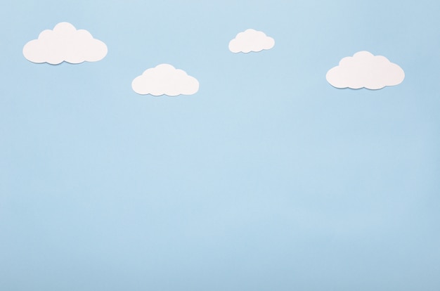 White paper clouds on a blue background