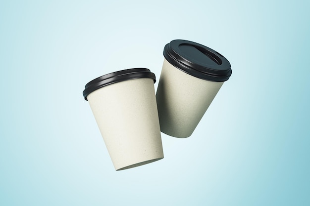 White paper coffee cups with black plastic caps with copyspace\
for your logo at light blue background mockup