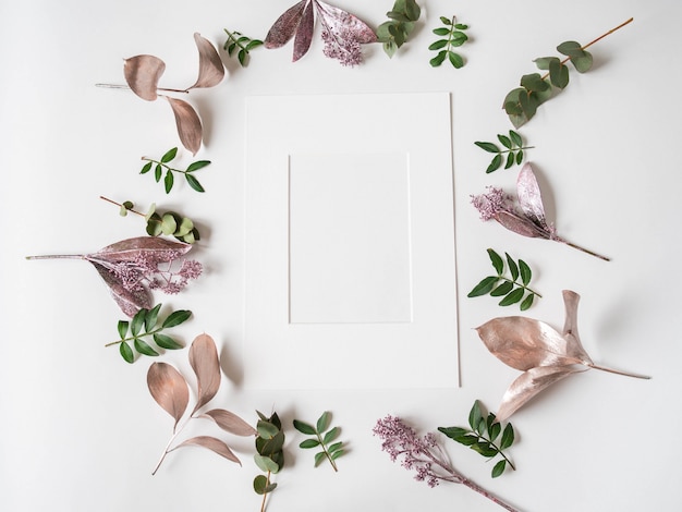 White paper frame and creative frame composition of various painted leaves and green leaves