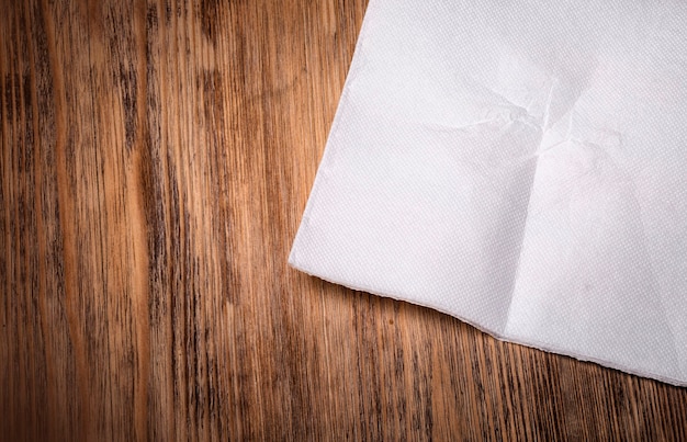 White paper napkin on old wooden table