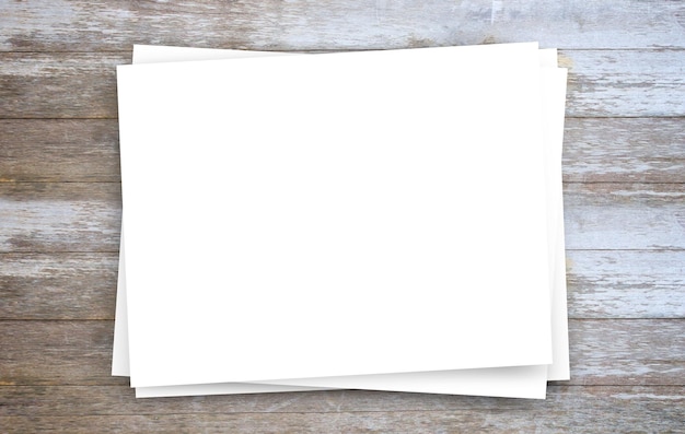 White paper or notepad on brown wood table background