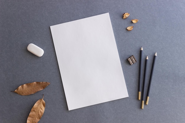 White paper and pencils on a gray background Design Mock up Copy space