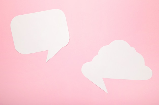 White paper speech bubbles on pink background