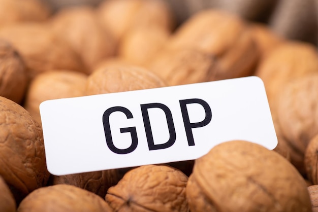 White paper with inscription GDP on walnuts