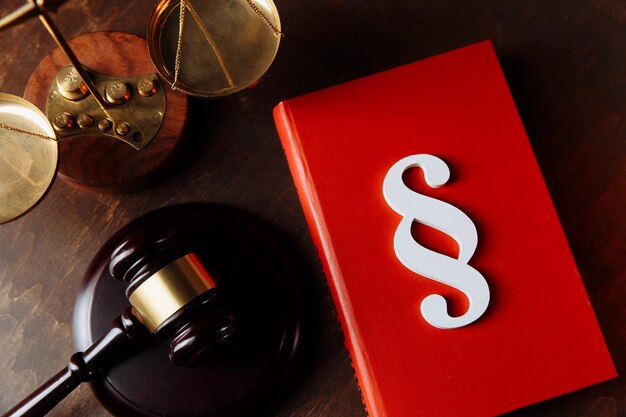 White paragraph symbol on a red book and judge gavel