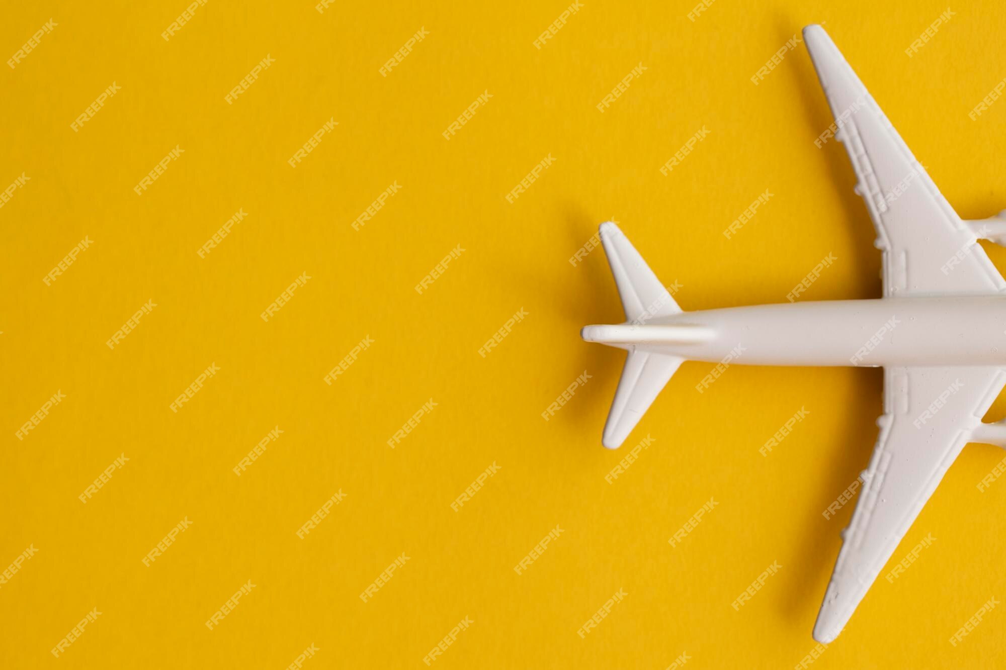 Premium Photo | White passenger airplane on a summer yellow background. travel and vacation background. Premium Photo | White passenger airplane on a summer yellow background. travel and vacation background.