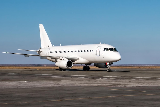 공항 앞치마에서 택시를 타고 있는 흰색 여객기