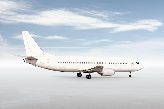 White passenger jetliner isolated on bright background with sky