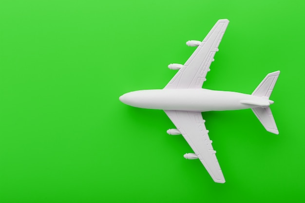 White passenger model airplane on a bright green background